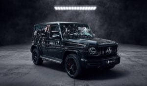 SUV noir haut de gamme photographié dans un studio sombre, au design robuste et luxueux